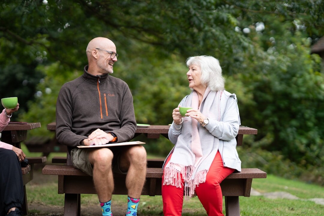 senior friends chatting in park