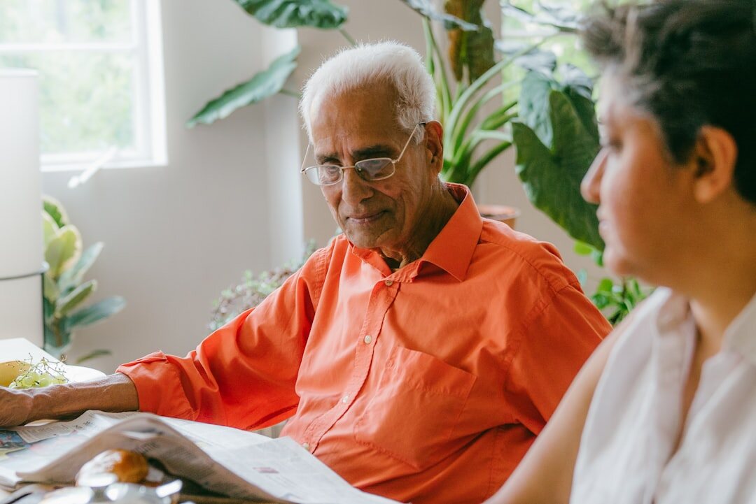 elderly man checking documents