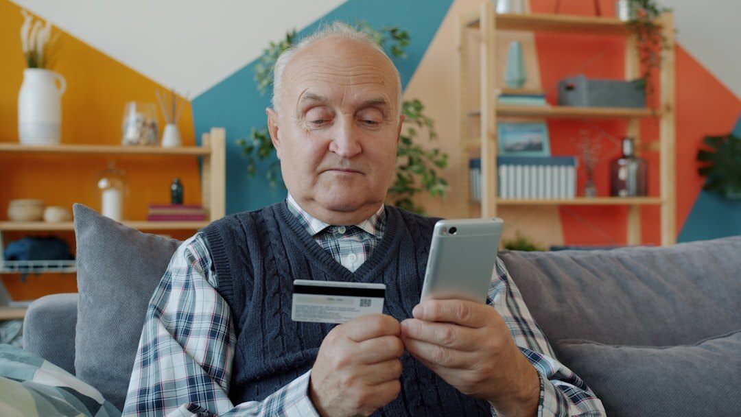 Croatian senior man happily holding a membership card