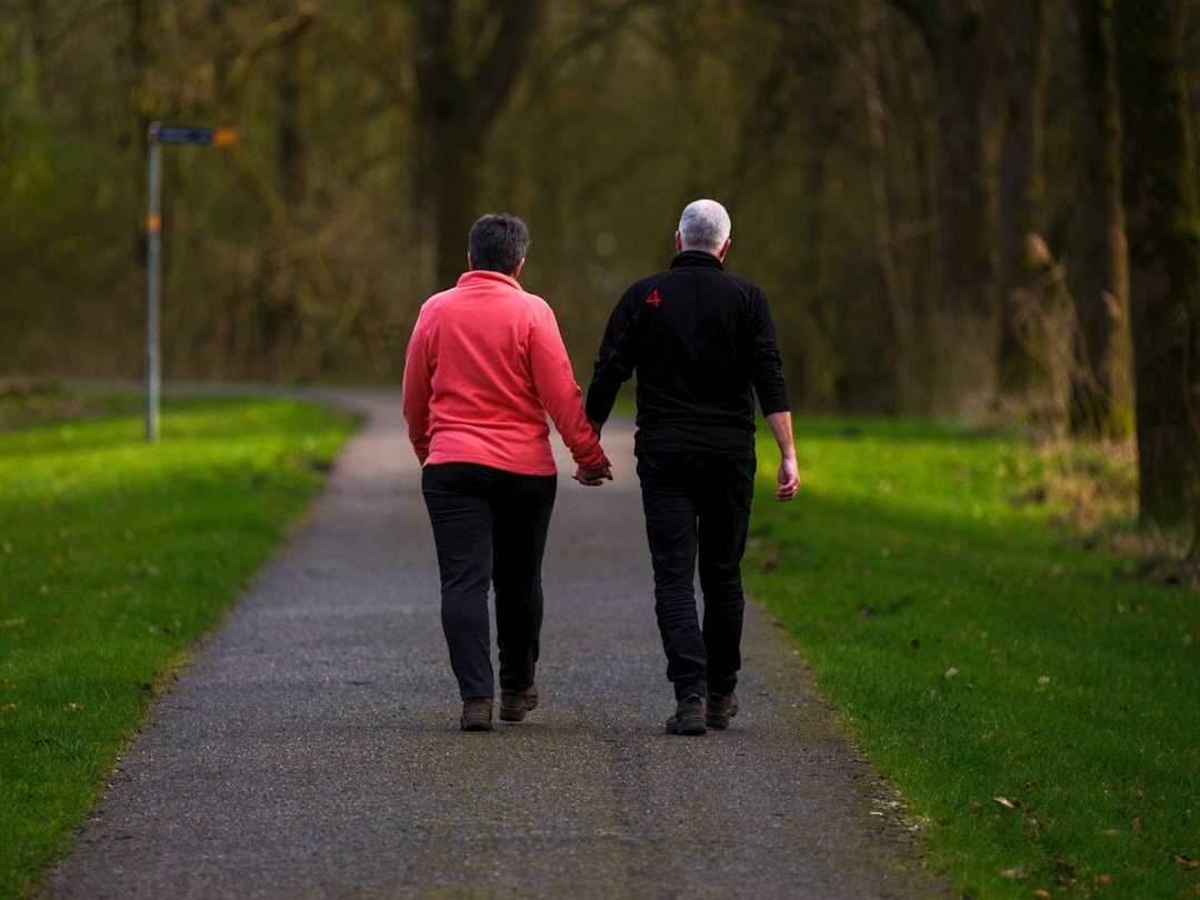 senior couple walking in park
